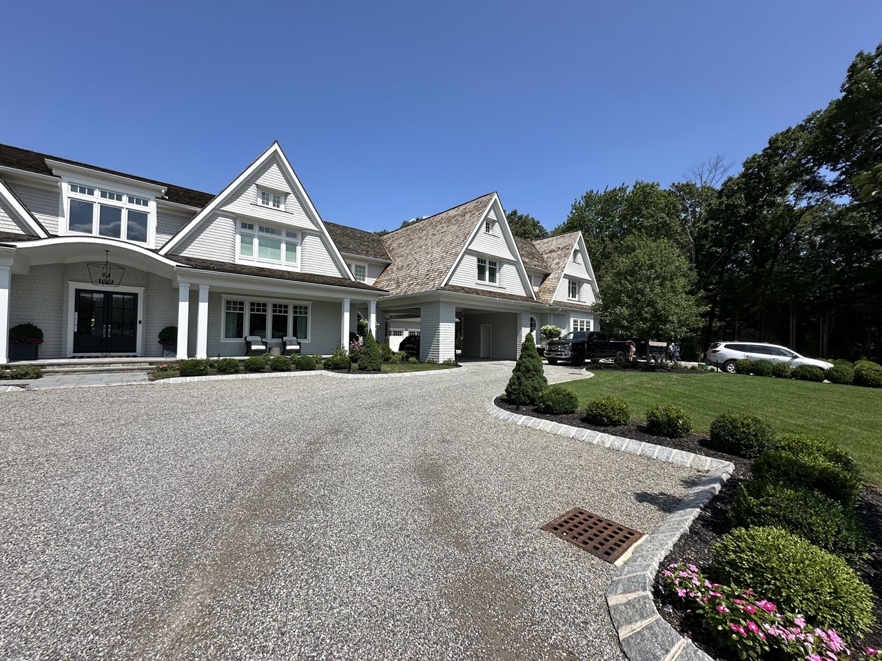 Shingle-style estate with granite-edged gravel driveway