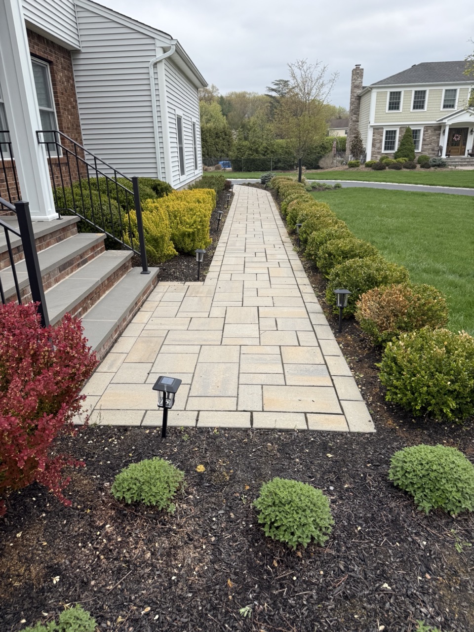 Stepping stone path through ornamental grass and perennial garden bed